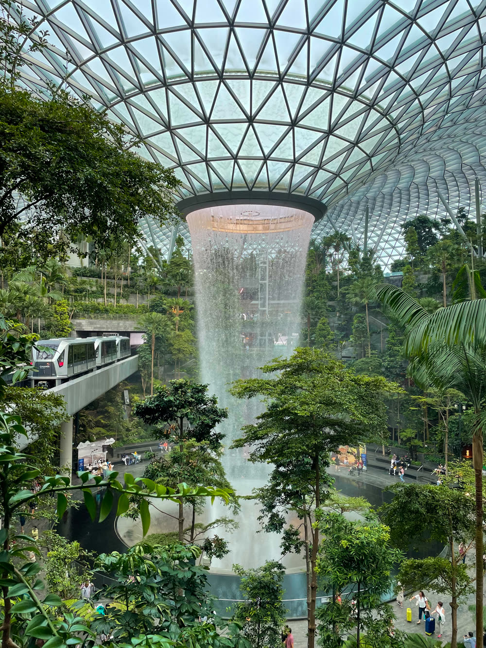 The Skytrain passing the indoor waterfall at Jewel Changi Airport, Singapore